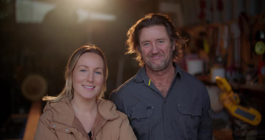 Portrait of a male and female standing in a garage
