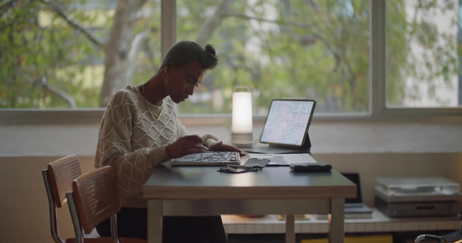 A woman is sitting at the table working
