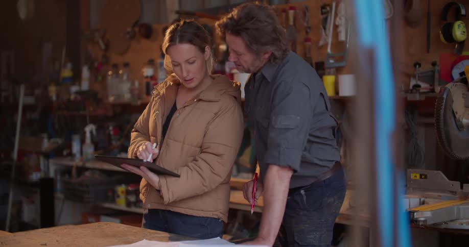 A woman and man are talking to each other in the factory