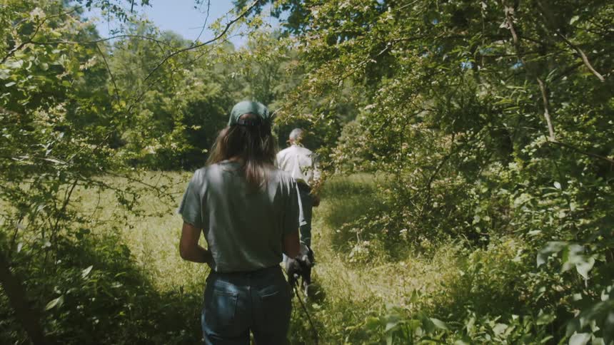 Man and woman are hiking outdoors through the wilderness