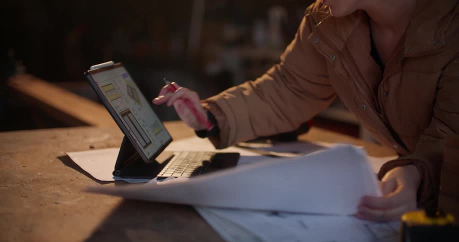 A blonde woman is working on her laptop indoors