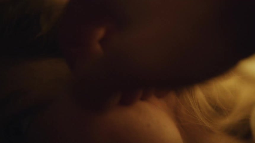 A man runs his fingers through his girlfriends long hair