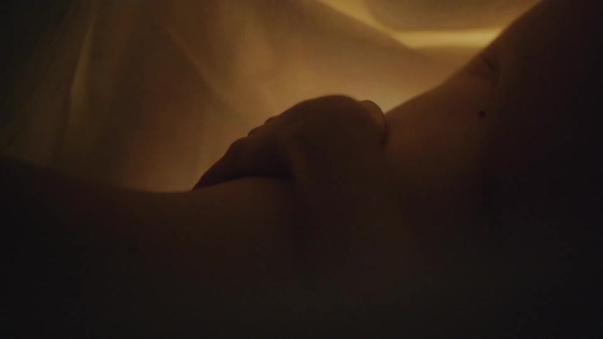 A woman touches her partners bareskinned lower back