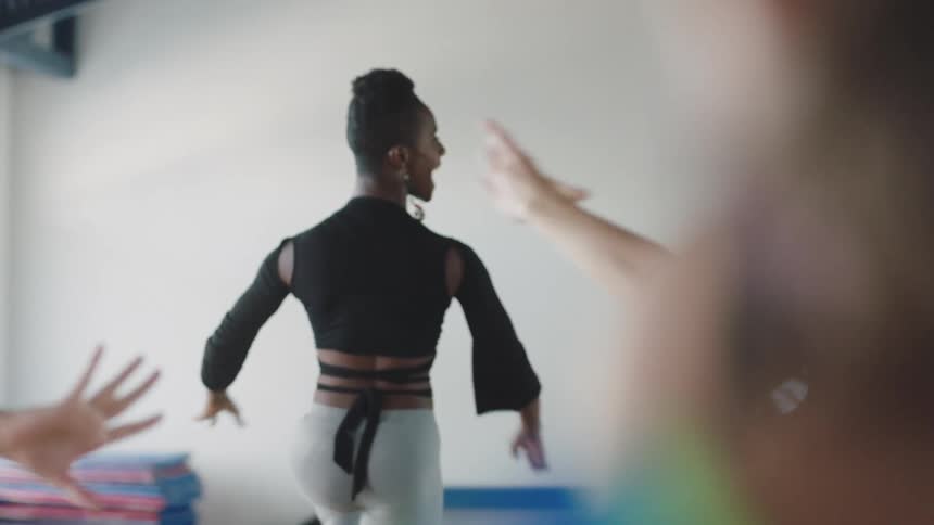 A group of woman are dancing in the day time
