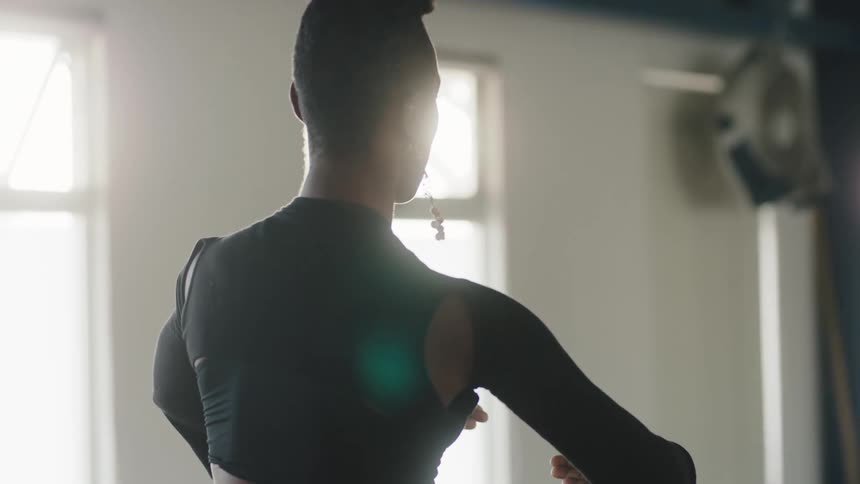 A dance instructor demonstrates a move
