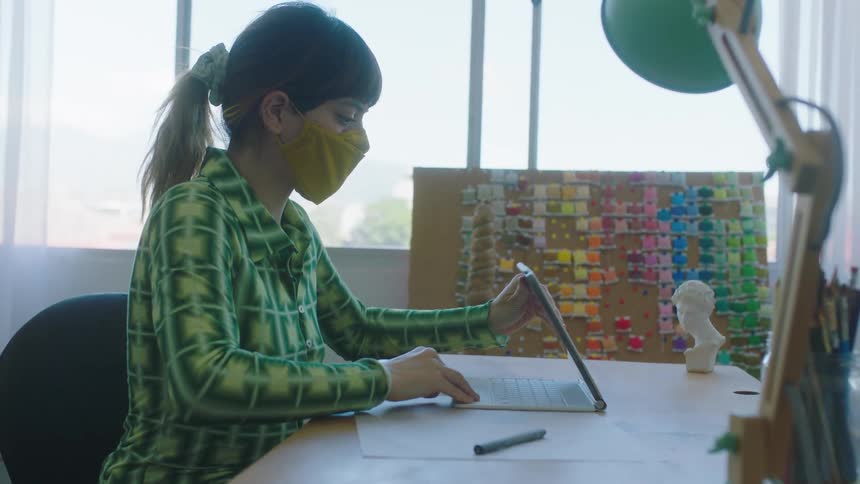 A young woman is working in a office in the day time