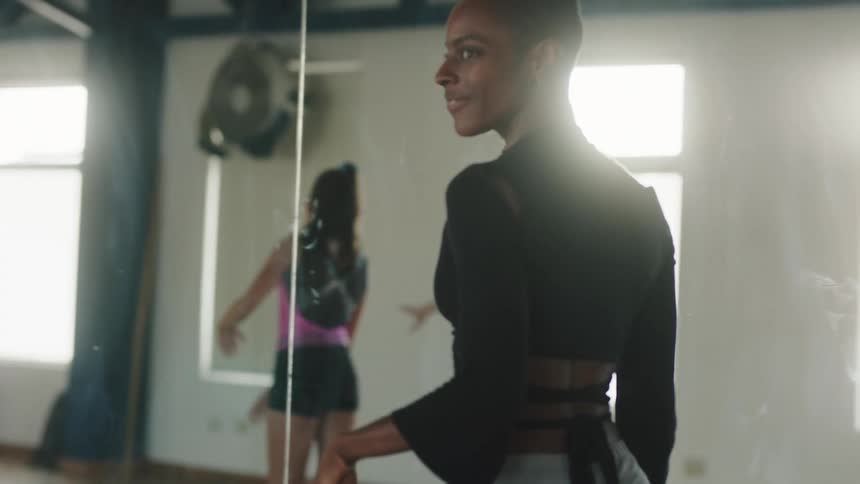 Women are dancing in a gym during day time