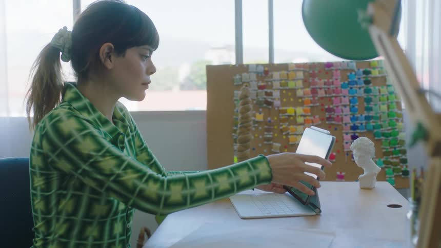 A young woman is working in a office in the daytime
