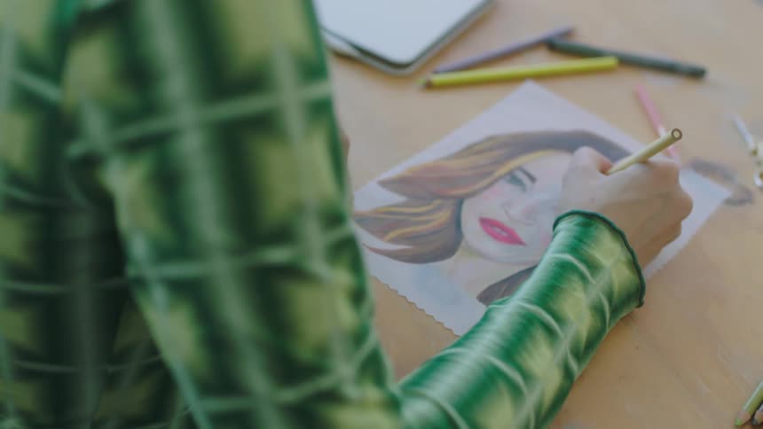 A female is drawing a picture of someone
