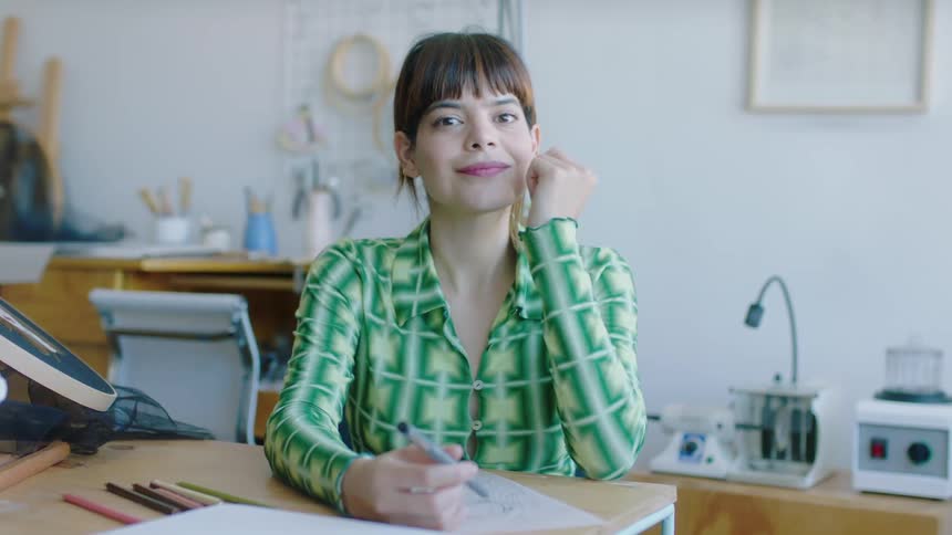 A woman is sitting in a chair in her office