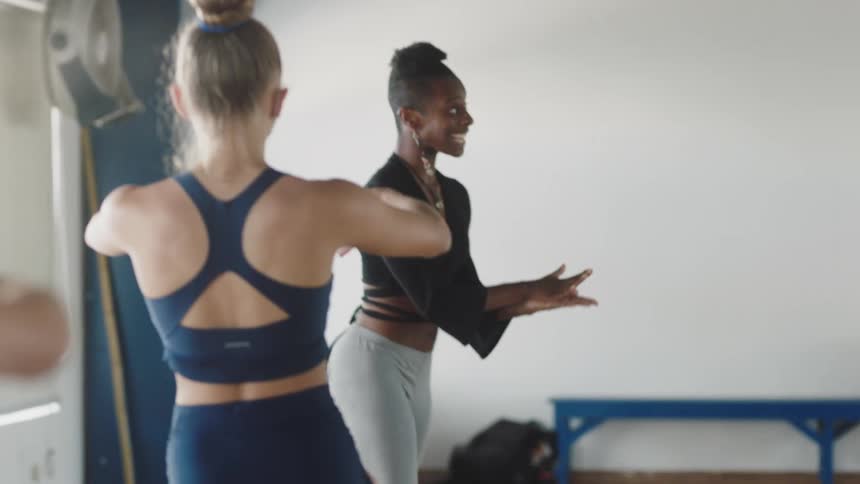 A group of girls are exercising together in the daytime