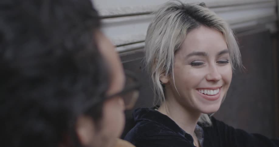 A woman laughing and smiling with a man