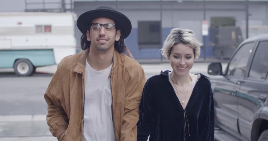 A man and woman walk on the street together