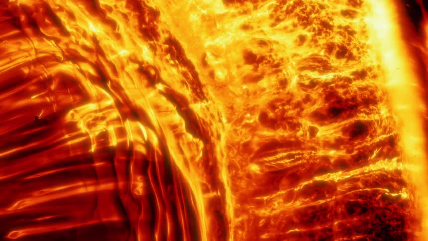 Yellow and red bright flames flow and converge like lava over a black background