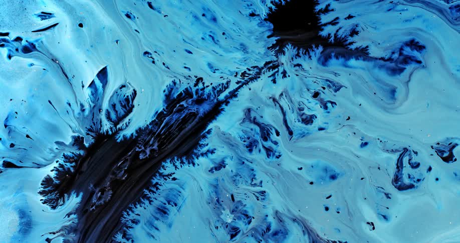 Bright white liquid ink flowing out in fractal shapes over a black background
