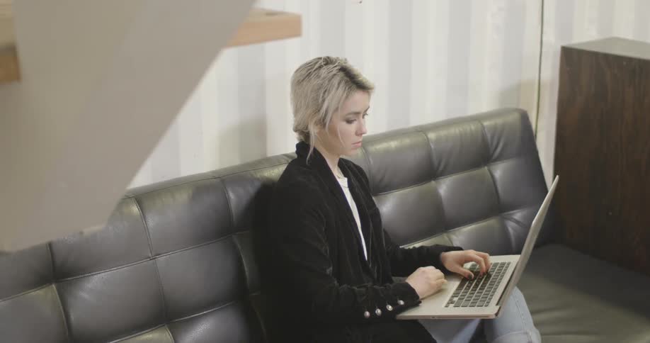 A young woman typing on a laptop