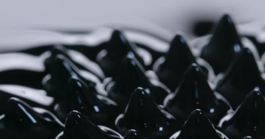 A viscous substance looks black as ink as it moves in waves