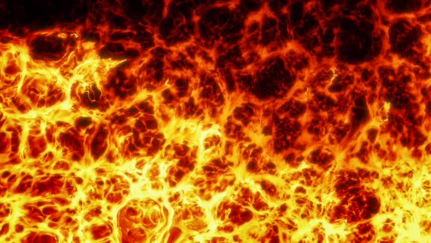 Yellow and red bright flames flow and converge over a black background