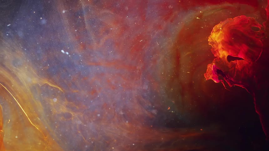 Clouds of flowing red and yellow ink swirling in liquid against a dark background