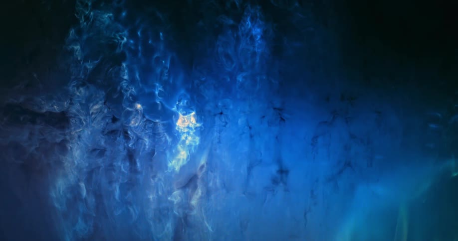 Bright electric blue luminous ink clouds flowing down on a black background