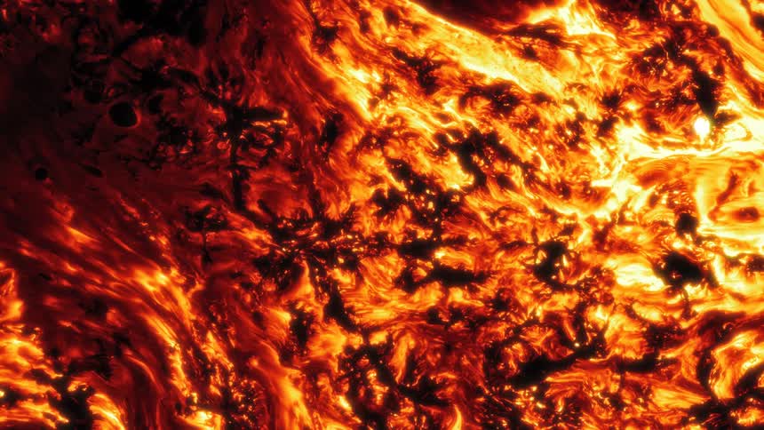 Yellow and red bright flames flow and converge over a black background