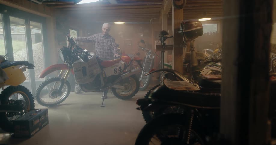 A man walking around a dirt bike