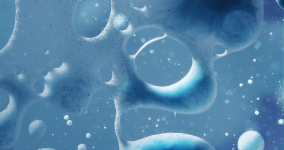 Bubbles expand and pop as they move in the blue liquid