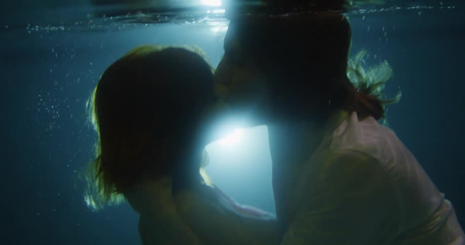 Boyfriend and girlfriend are kissing under the water