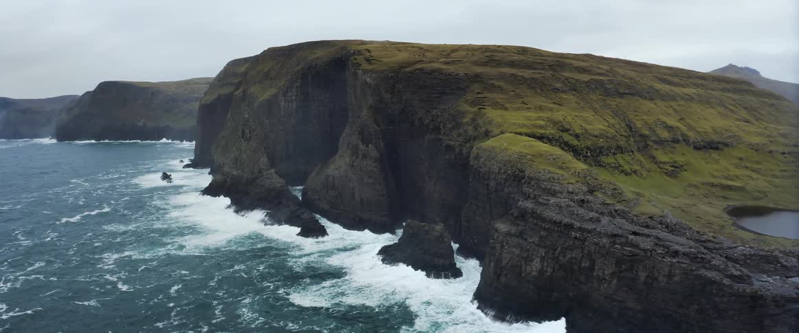 Aerial view of an island in the ocean is displayed during spring
