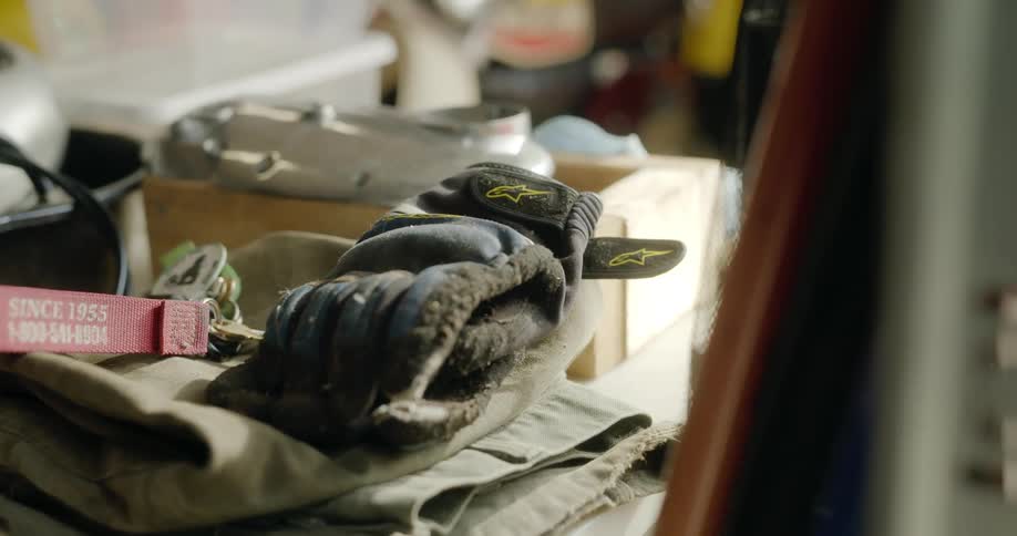A mans work gear is on a table in a room