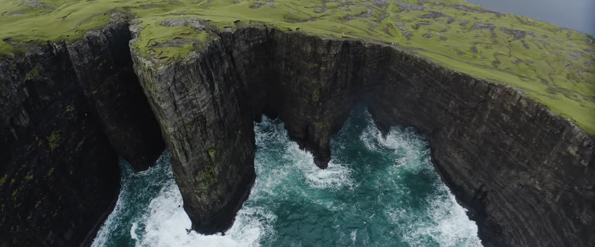 Aerial view of an island and an ocean is displayed in spring