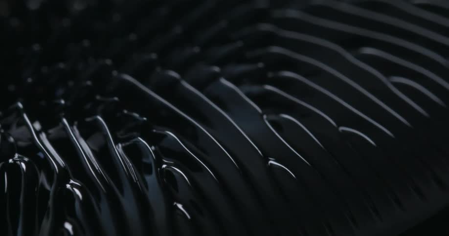 A black substance is moved along in a pattern