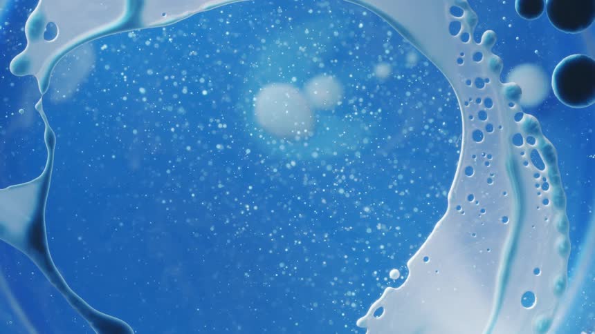 Blue and white liquid paint mixing together