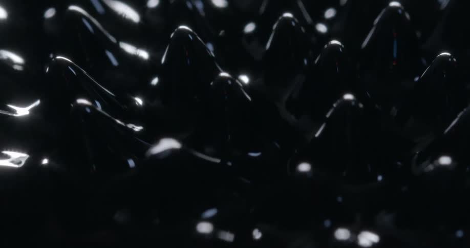 Nodules emerge from black oily liquid then submerge again