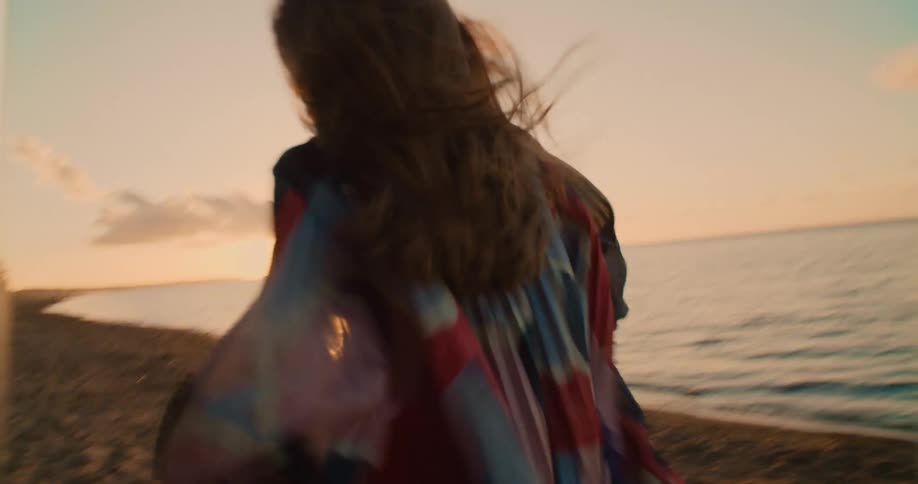 Man and woman are running on the beach together