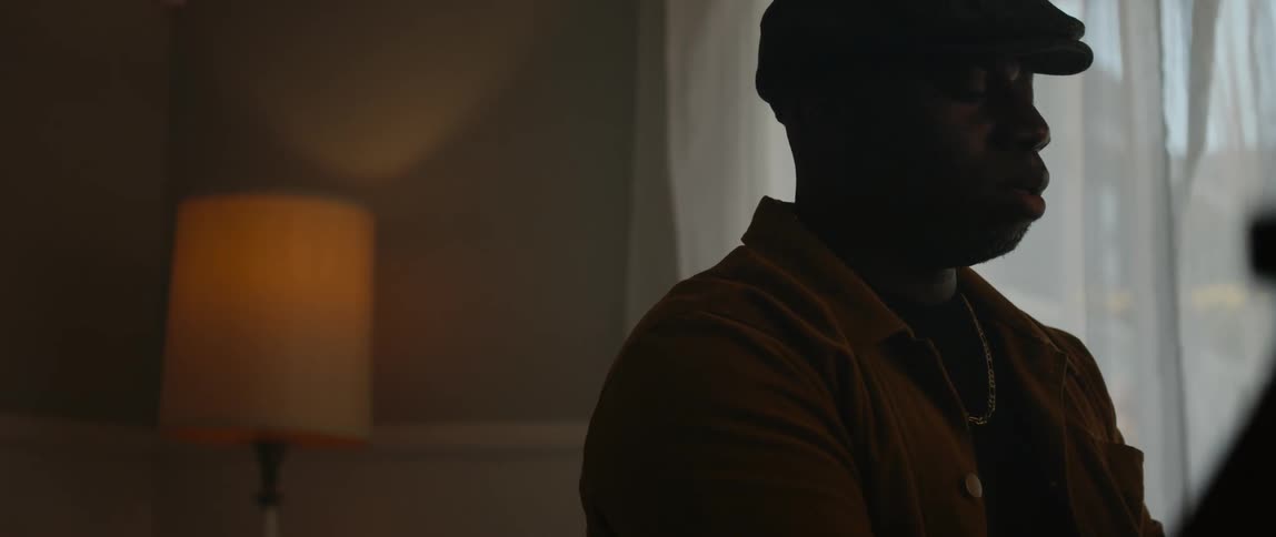 A man standing near the window in a room