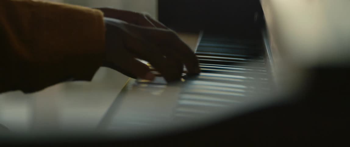 A person is playing the piano indoors