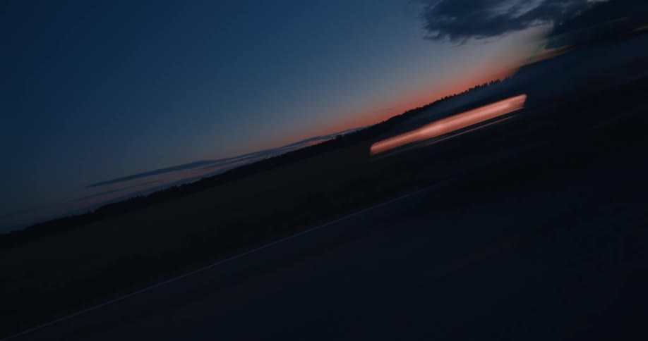 The view is of cars going by on the highway in the middle of the day