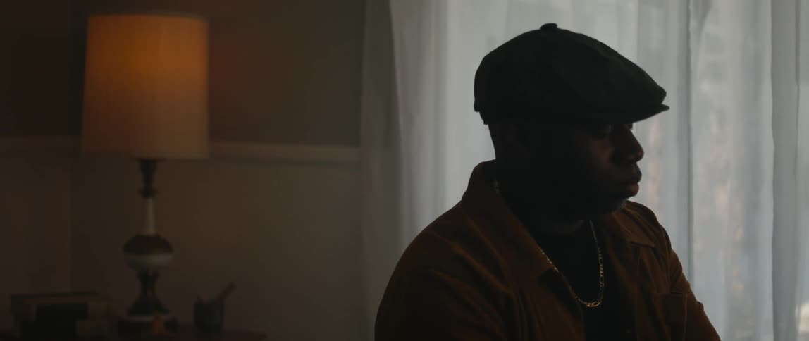 A man is playing the piano in his house