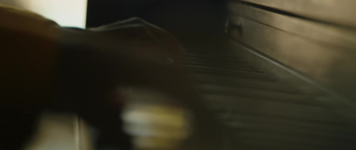 A person plays a piano indoors during the day