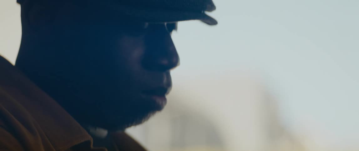 A side portrait of a man in front of a window