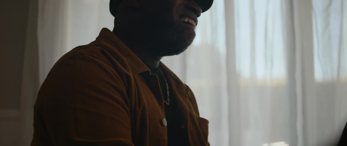 A young black man is singing in the middle of the day