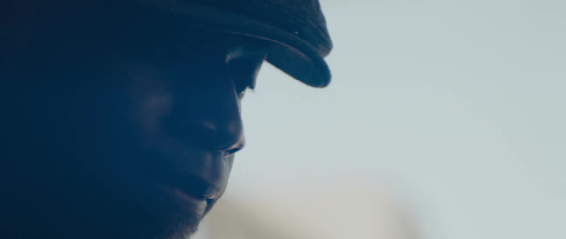 Close up view of a mans face while he is indoors