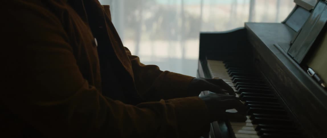 A view of a man playing a piano