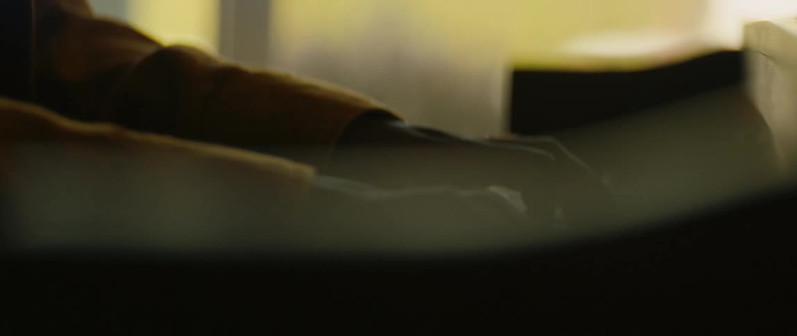 A young black man is playing the piano inside