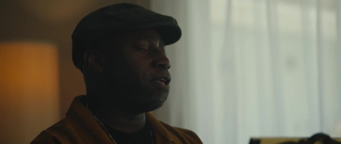 A man moves his head back as he sings and plays piano