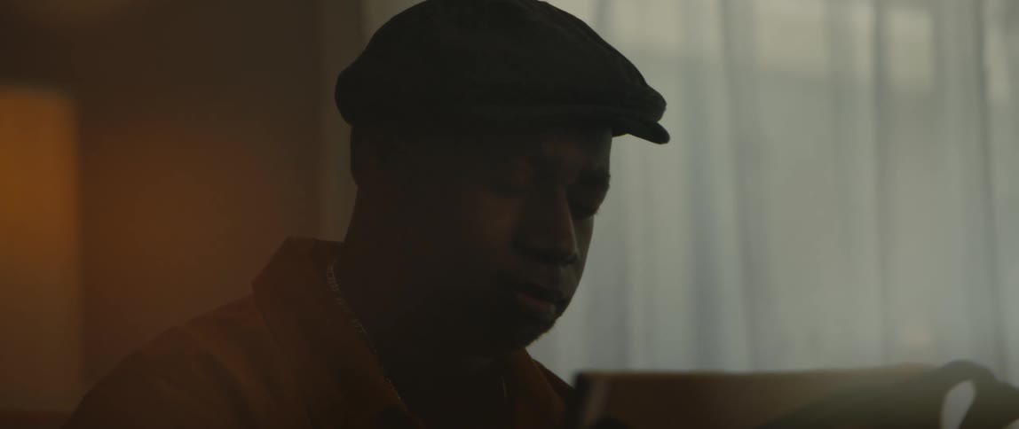 A man is sitting in a room by himself