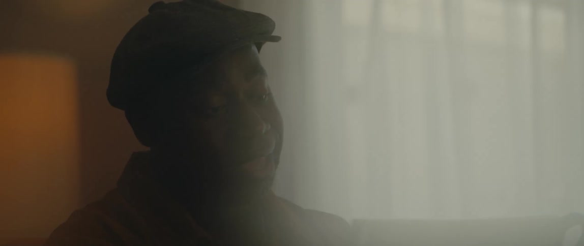 A man is sitting in his house near a window