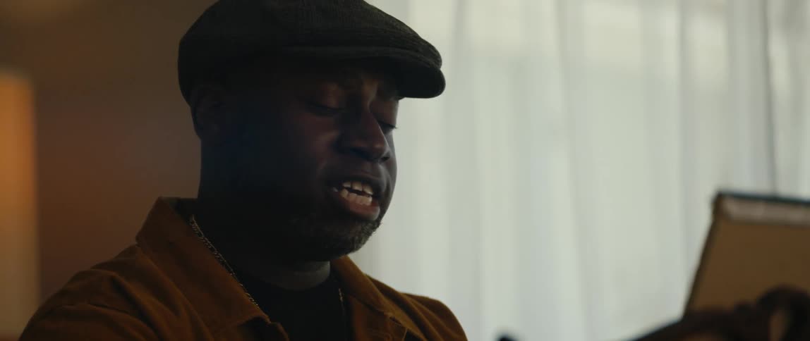 A man sings with emotion as he plays the piano