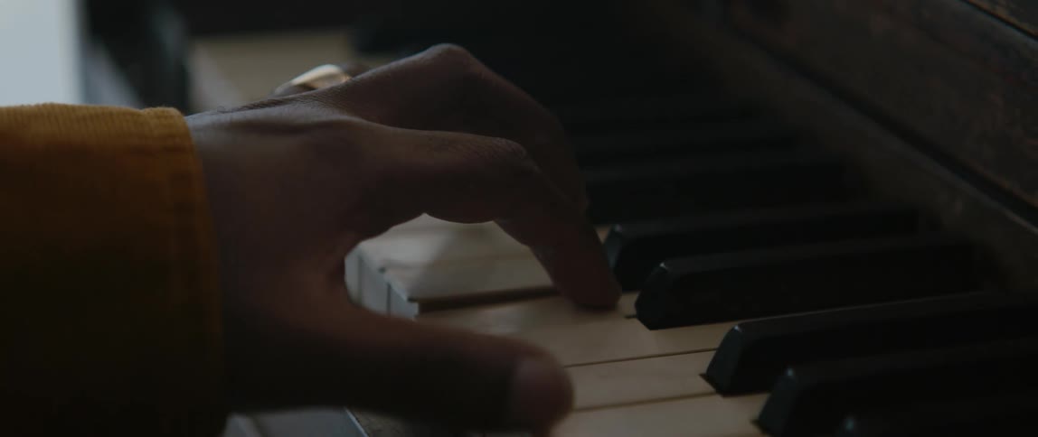A person playing the keys of a piano
